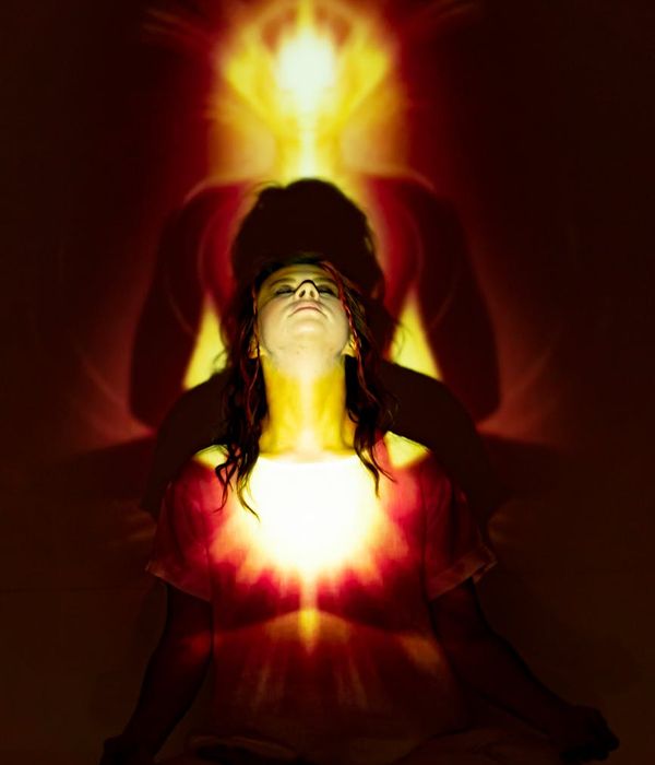 Woman in a serene meditative pose, surrounded by a calm aura.